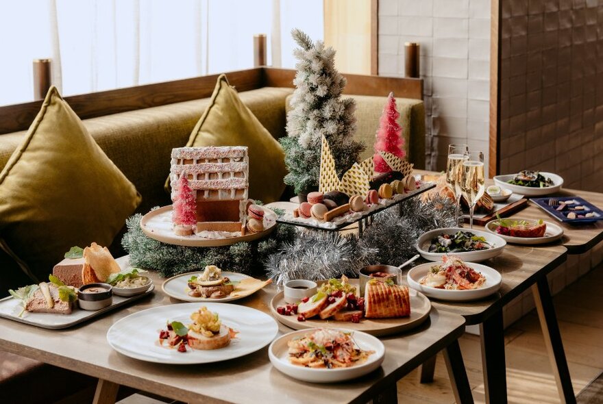 A festive dining setup featuring a Christmas dining experience on a table, with banquette seating.