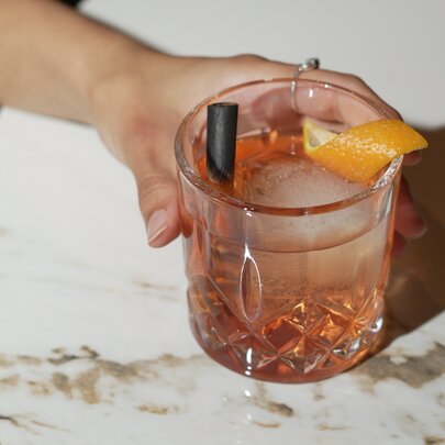 A person holding a cocktail.
