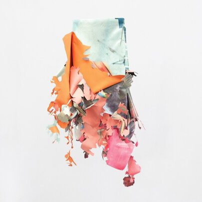 A sculptural piece hanging on a white gallery wall, made from vinyl, acrylic paint, graphite, and tape.