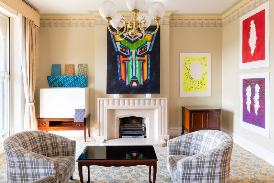 A room at the Hotel Windsor decorated with art works hanging on the walls.
