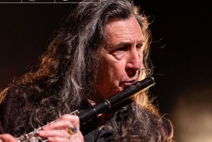 Spanish musician Jorge Pardo playing a flute.