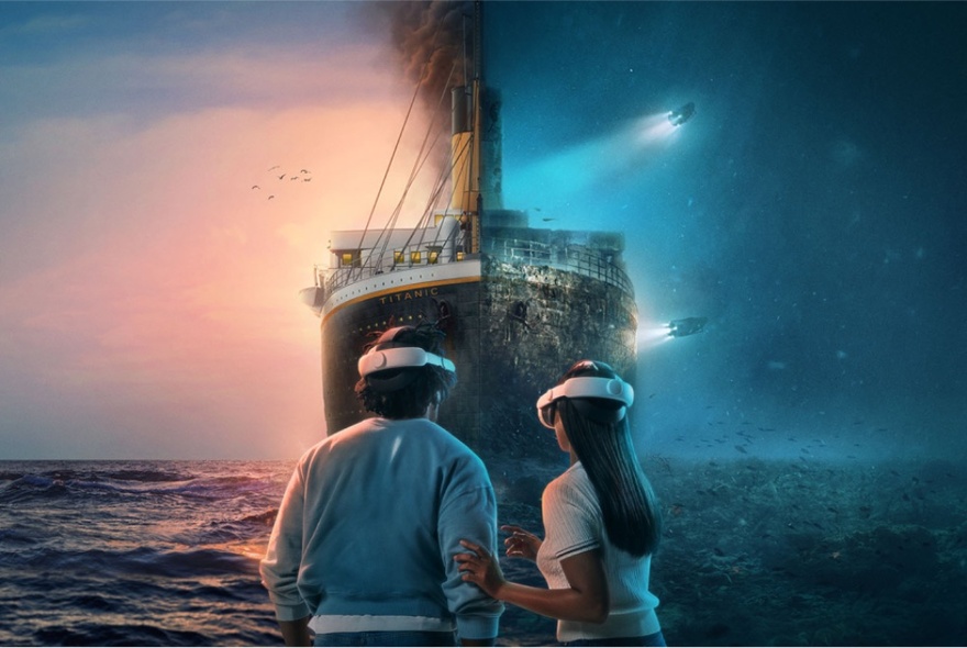 Two people wearing VR headsets standing in front of an replica of the Titanic, heading straight for them. 