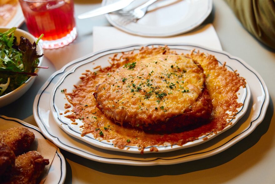 A parma surrounded by a crispy melted cheese skirt. 