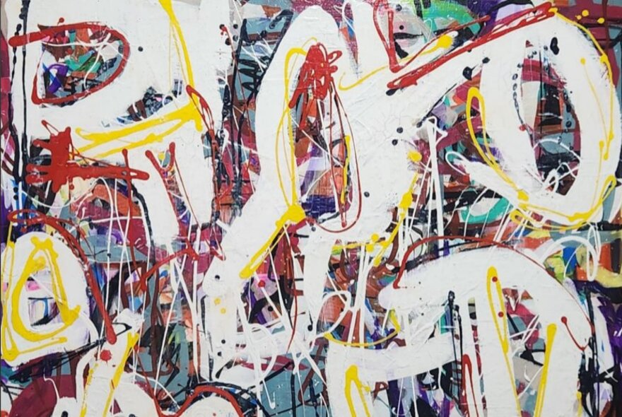 Abstract painting of splatter and drip marks and curved thicker white brushstrokes over the top.