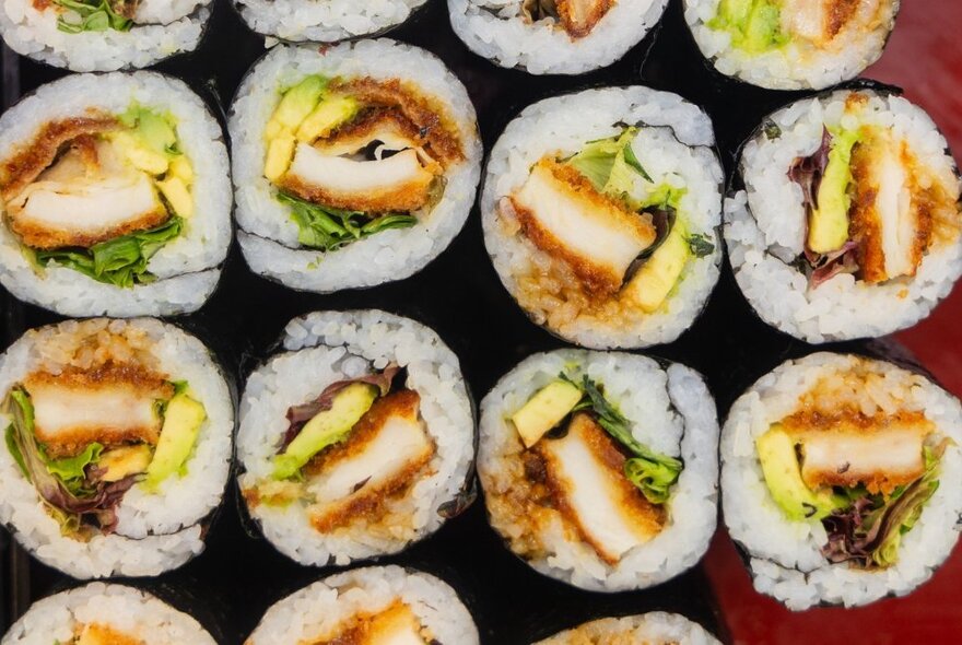 Overhead view of a plate of sushi rolls.