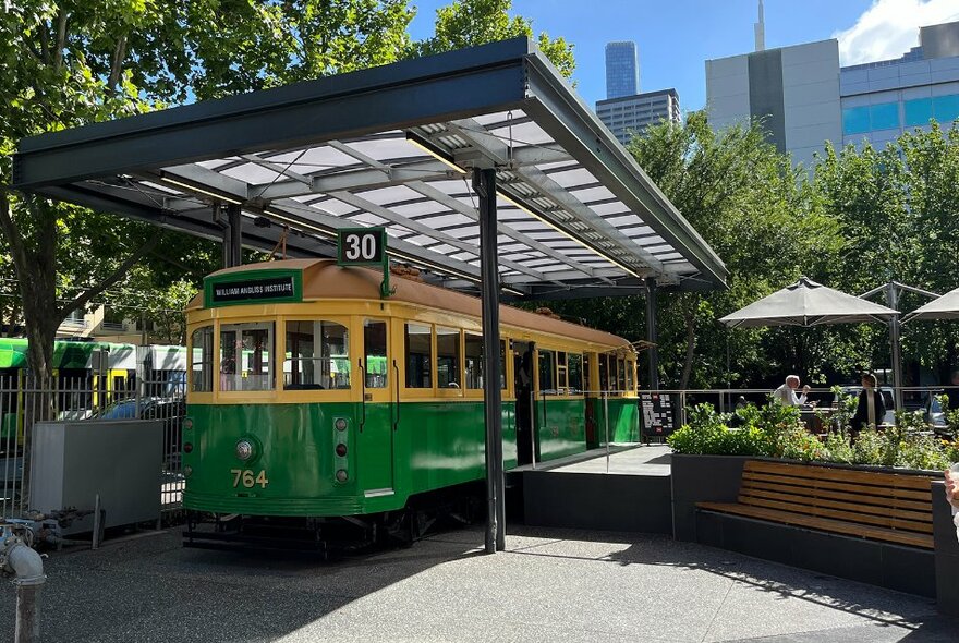 A cafe in the city with an old style tram for seating.