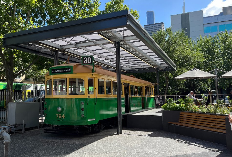 A cafe in the city with an old style tram for seating.