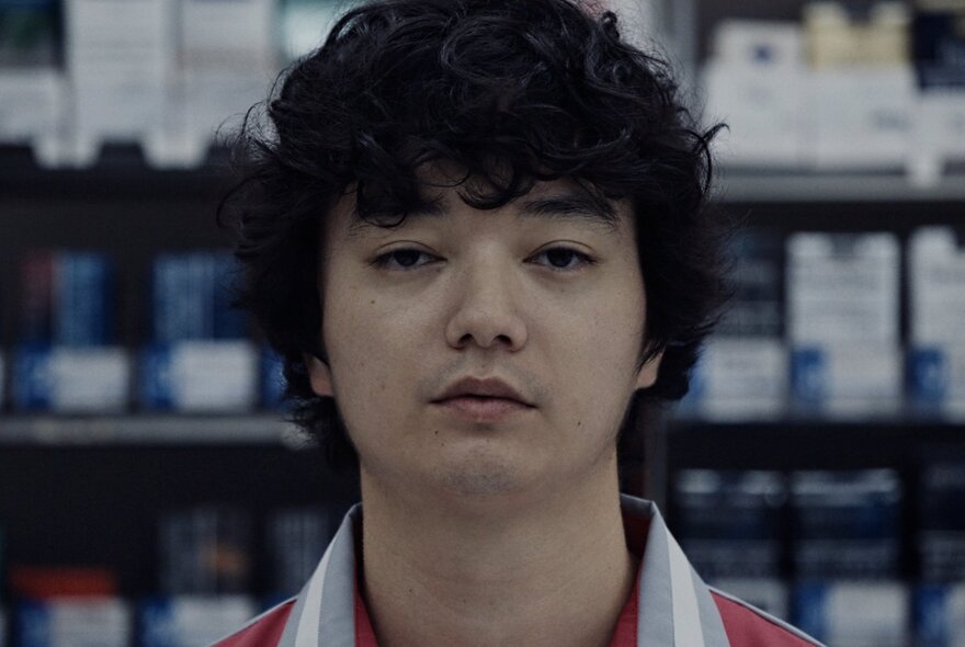 Japanese actor Shōta Sometani as a convenience store clerk in a still from the surrealist horror-comedy film AnyMart.