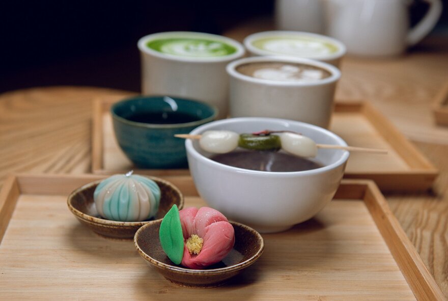 Japanese drinks and sweets on wooden trays, including matcha.