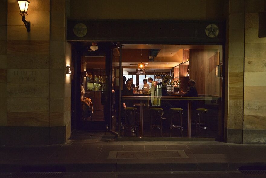 Outside a restaurant at night. 