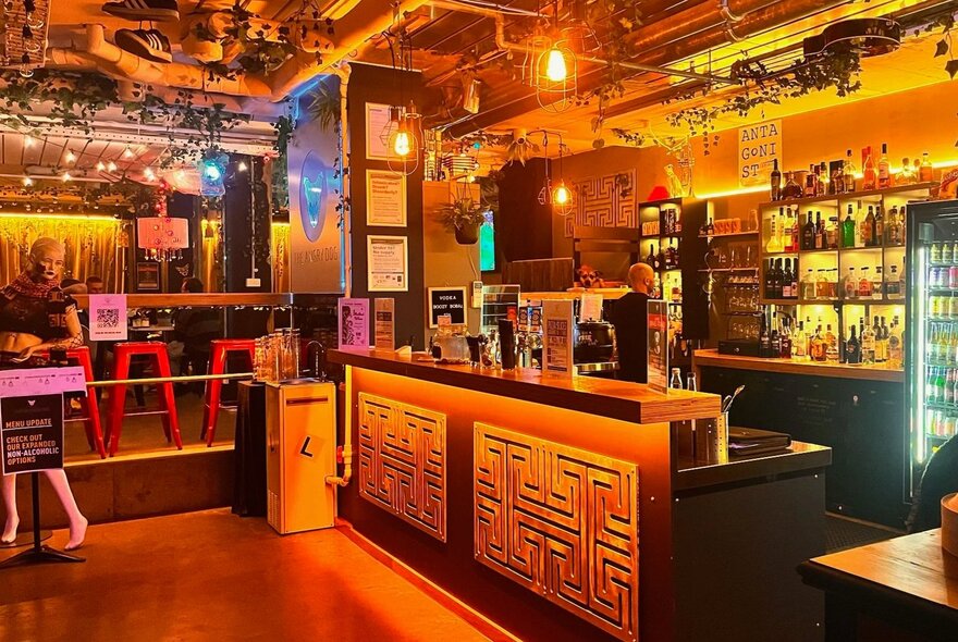 The industrial style space at The Angry Dog, with exposed pipes on the ceiling, and a bar area to the right.