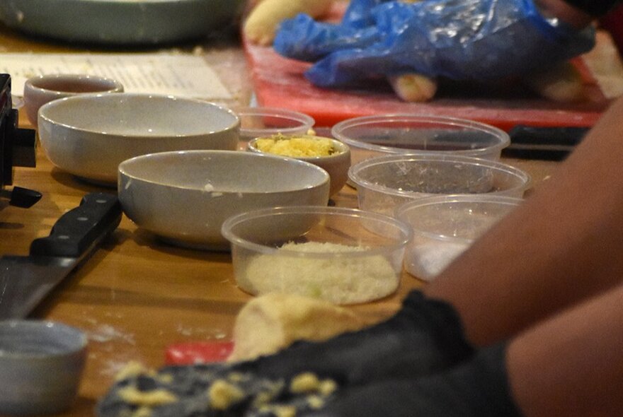 Bowls of food on a workshop table during a cooking workshop.
