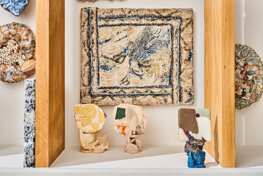 Small framed artworks on display on the white walls of the gallery space at Craft.
