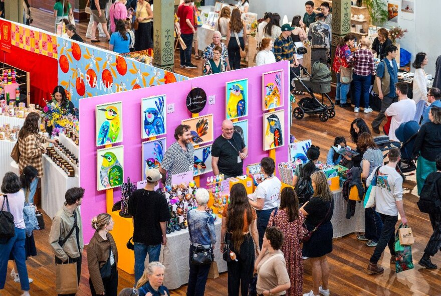 Crowds of people browsing designer stalls at the Big Design Market inside the Royal Exhibition Buildings.