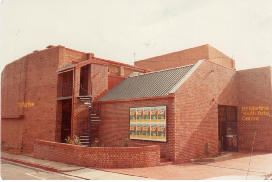 Modern red-brick building with diagonally shaped rooflines.