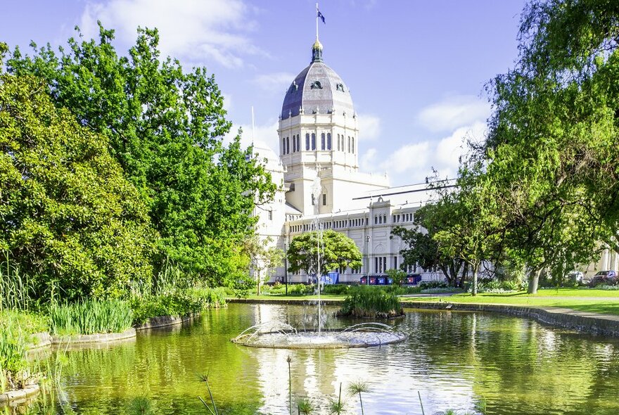 A huge historic building with a dome in a park