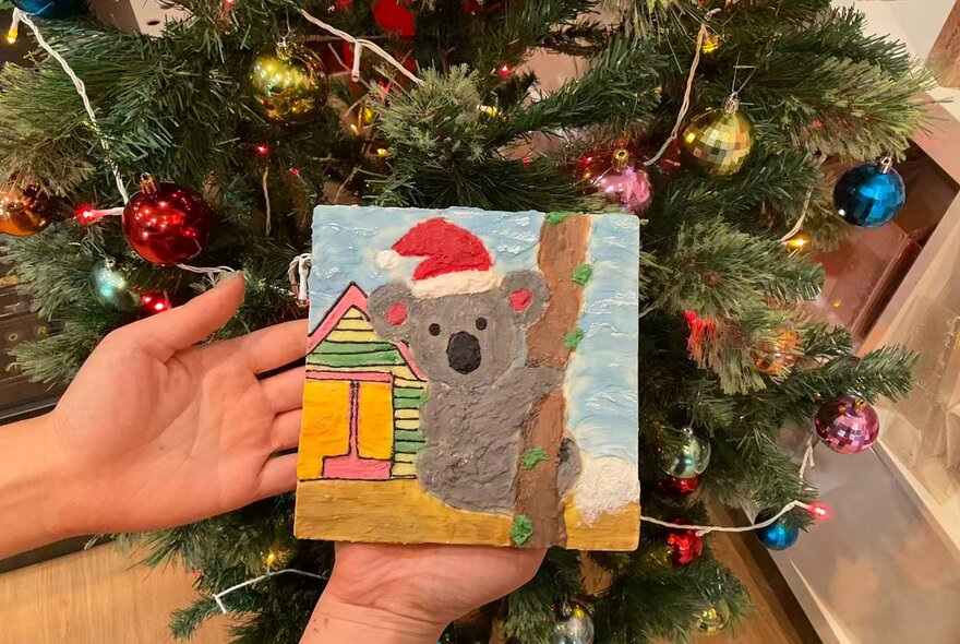 A simple painting of a koala wearing a Santa hat made entirely from chocolate.
