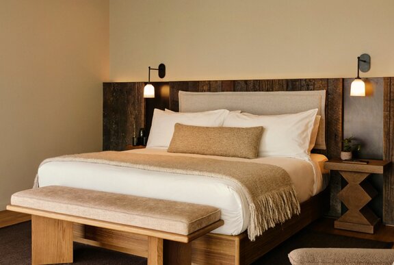 A neatly made queen size hotel bed.