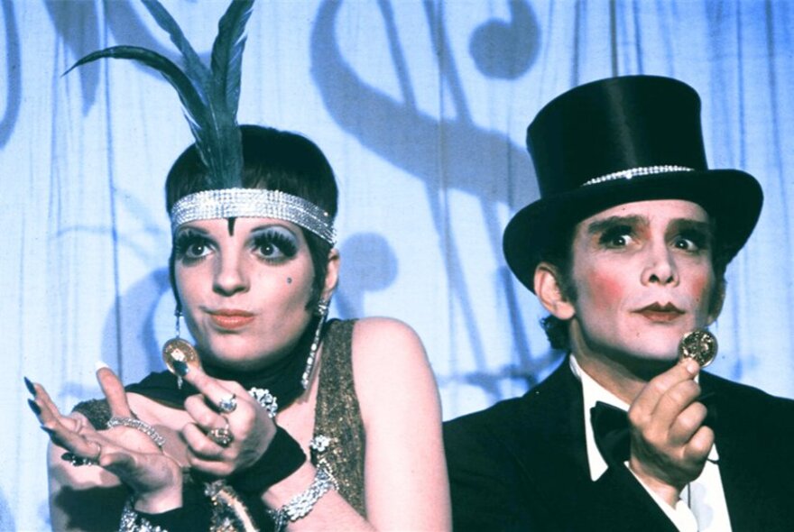 Liza Minelli and Joel Grey performing wearing 1930s vaudeville costume in a still from the movie Cabaret.