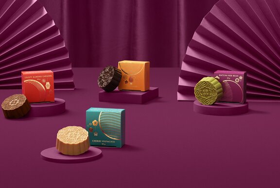 A selection of different flavoured moon cakes in colourful packaging.
