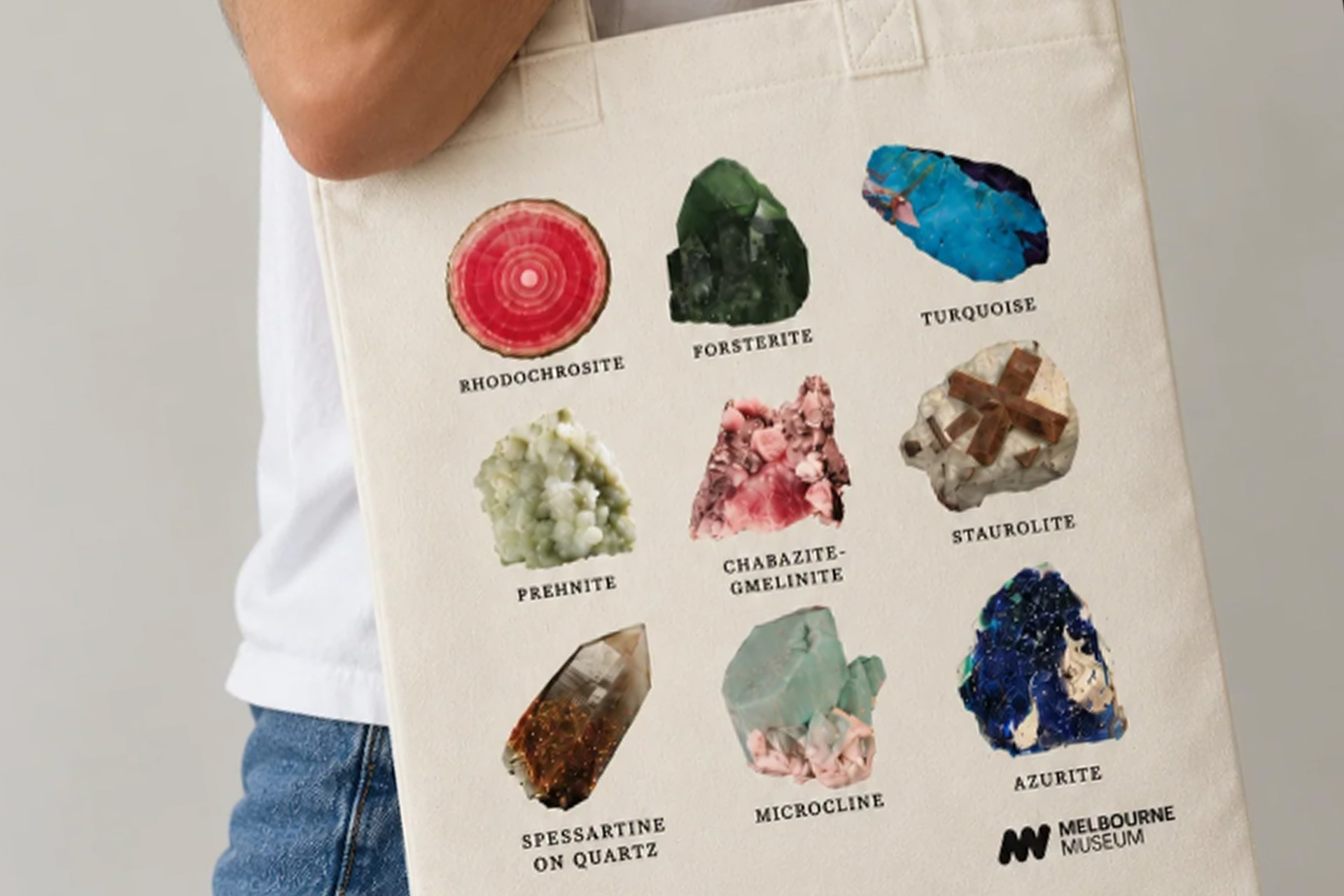 A tote bag featuring photos of gemstones