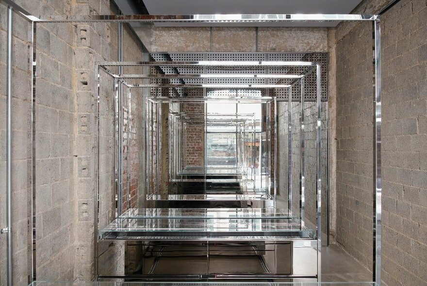 Interior of jewellery store with exposed  brick walls and glass display cases of jewellery.