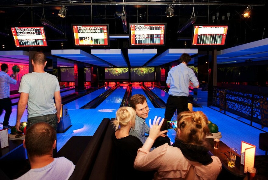 People enjoying tenpin bowling.