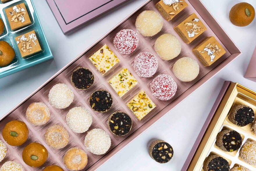 Looking down on a box of small sweet cakes in rows of three. 