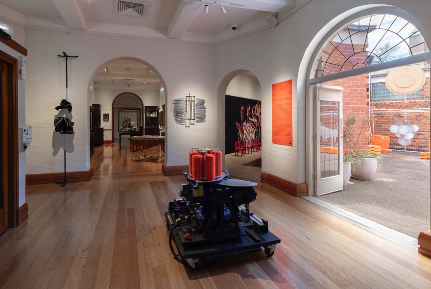 Museum interiof with ornate doorway and subtly lit exhibits.
