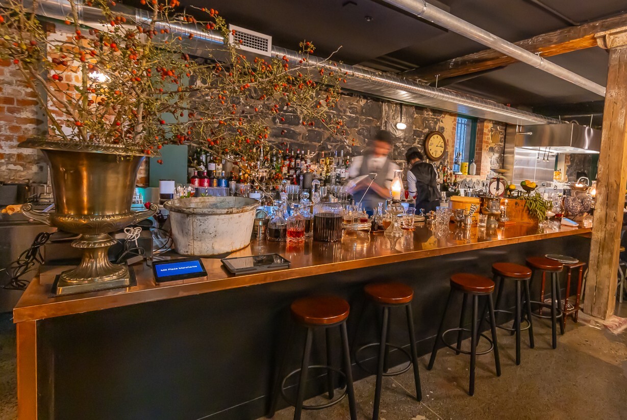 Bluestone bar topped with bottles of liquor