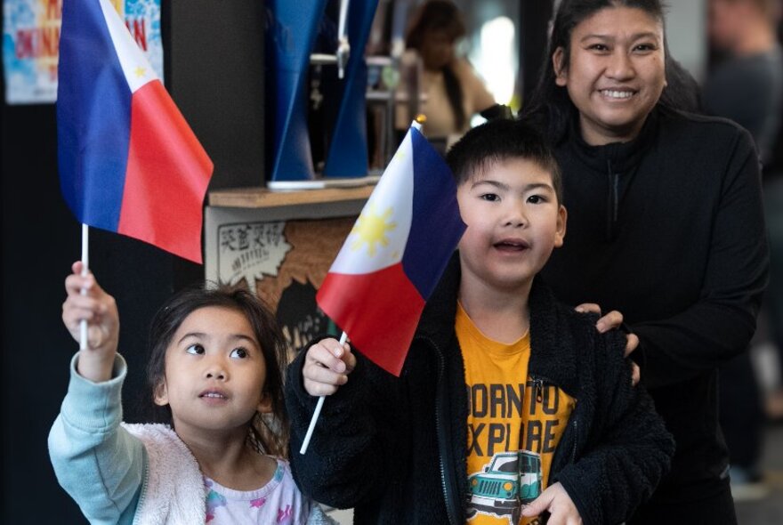 Two children waving Filipino flags.