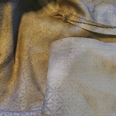 Layered satin fabric in yellow and pink with embossed pattern.