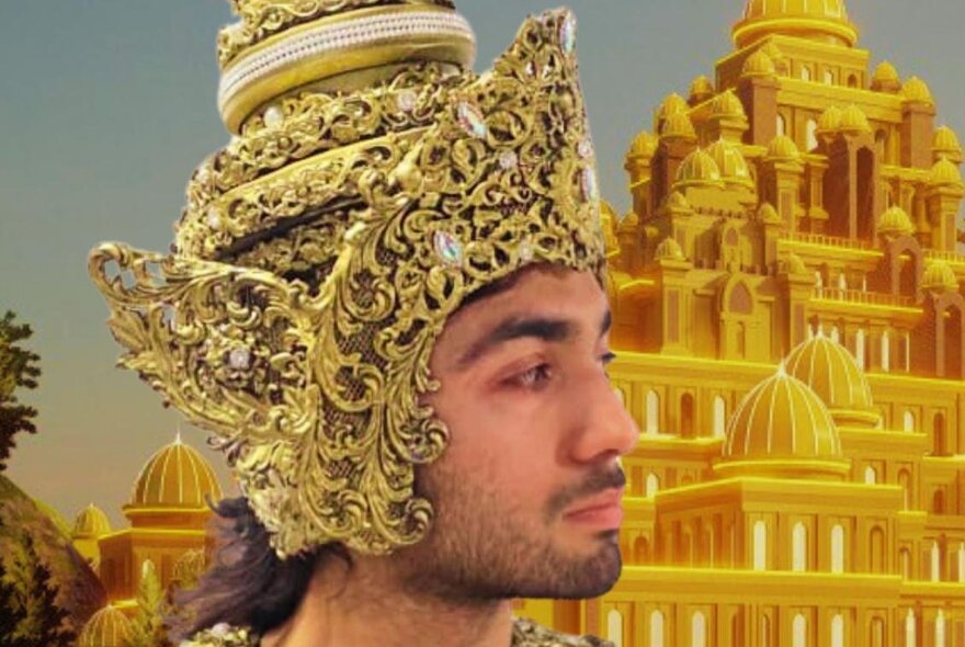 An Indonesian man wearing an elaborate gold headdress in front of a golden multi-tiered temple.