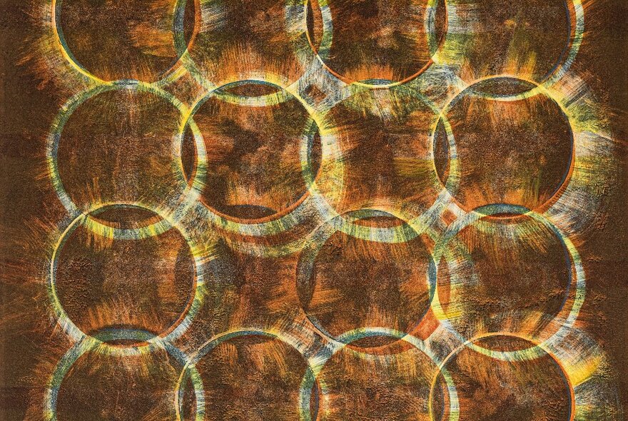 An abstract artwork comprising overlapping circles in shades of brown and pale yellow.