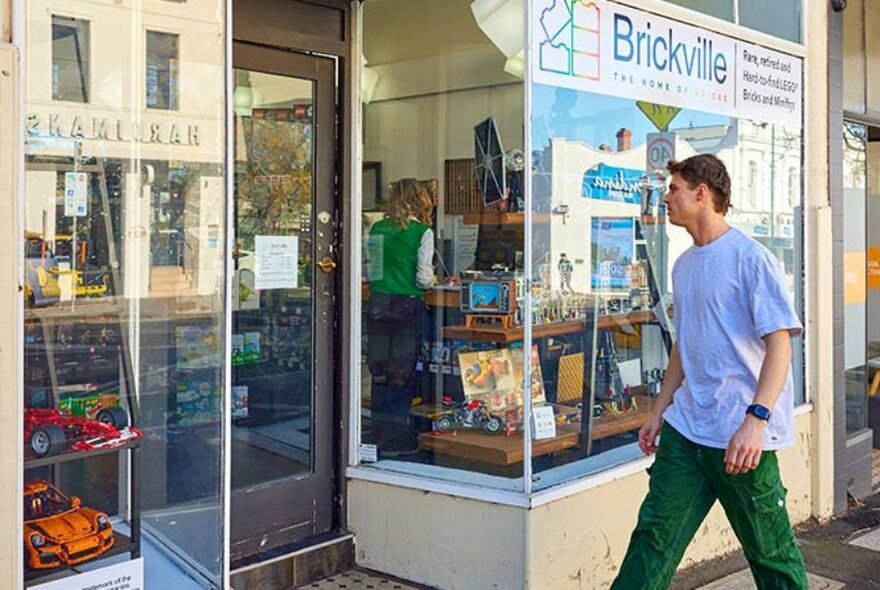 Person entering Brickville Lego store.