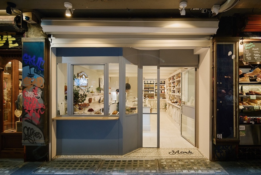 The brightly lit exterior of the Mork Chocolates shop in Centre Place, with an open door showing a clean white space inside. 