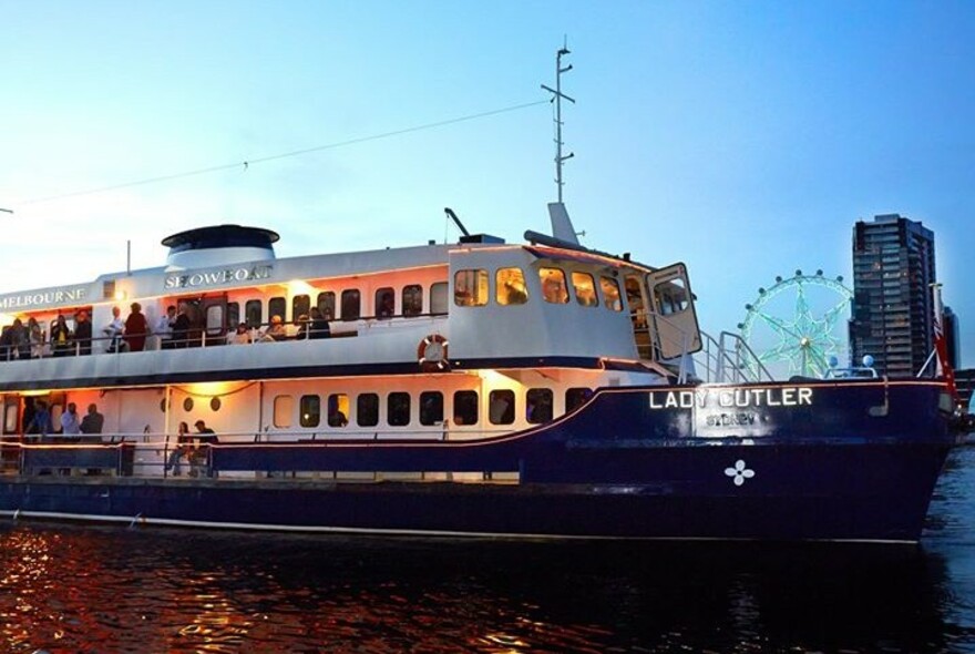 Lady Cutler boat on the Yarra River with Melbourne Star Observation Wheel in the background.