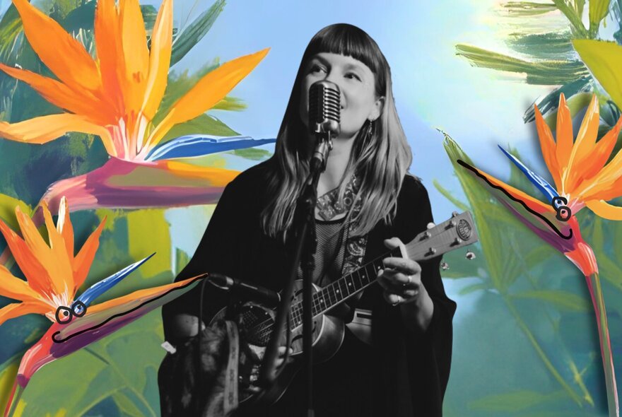 Woman playing guitar surrounded by bird of paradise flowers.