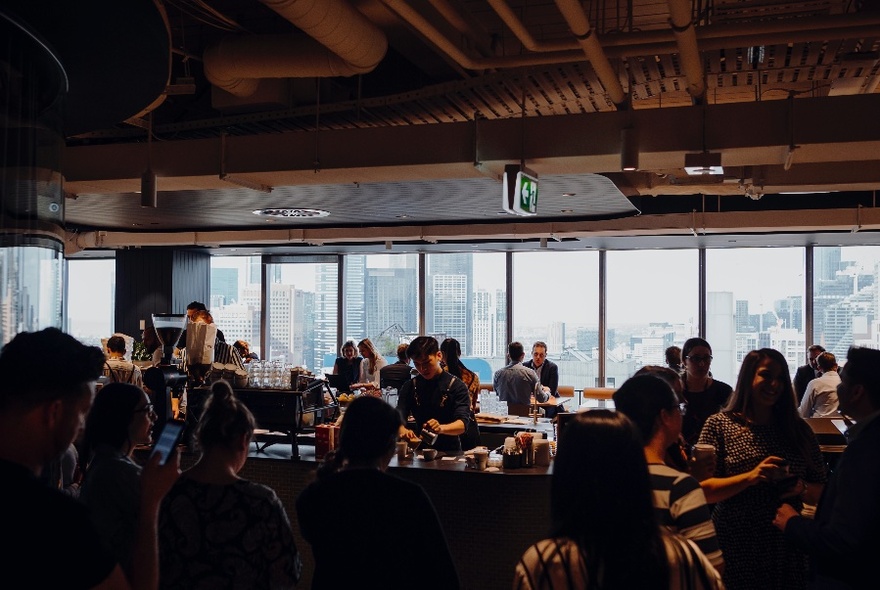 Crowded, modern cafe with city views.