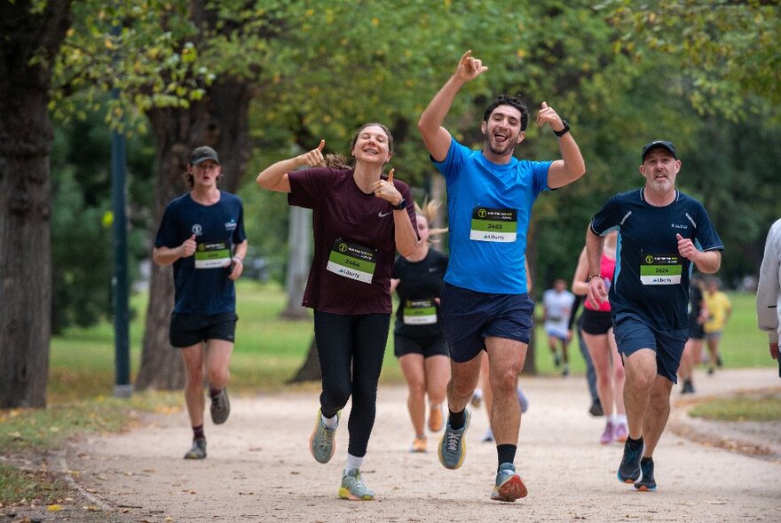 A group of people enjoying a fun run through Melbourne's Botanic Gardens.