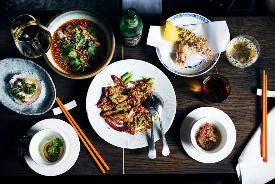 Plates of Chinese food and chopsticks.