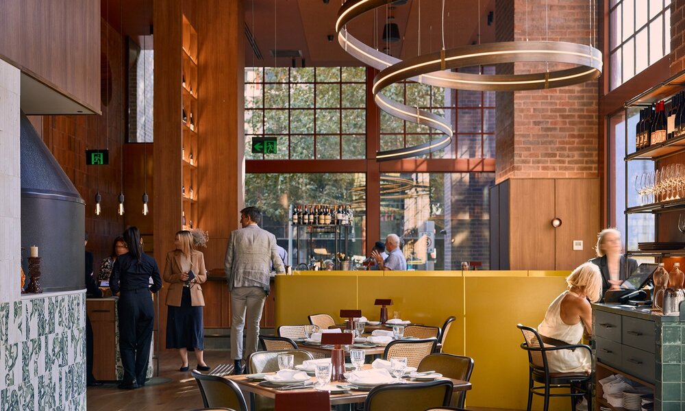 A fine dining restaurant with a swirling metal light fixture.