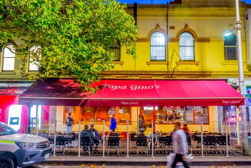 The outside of an Italian restaurant with a red awning