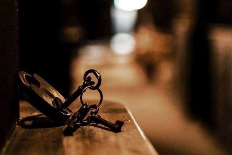Sinister-looking padlock and keys inside an escape room.