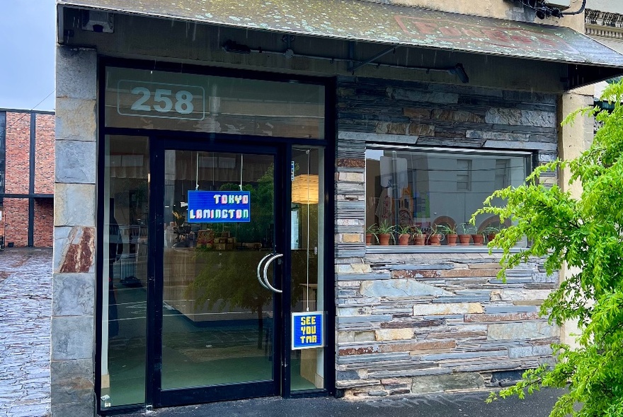 Exterior shopfront of Tokyo Lamington, showing large glass door and window.