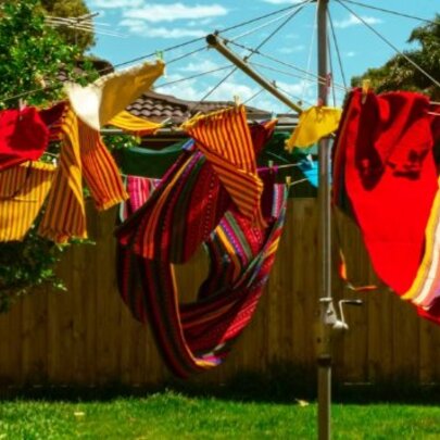 Red and gold washing blowing on a Hills Hoist clothes line. 