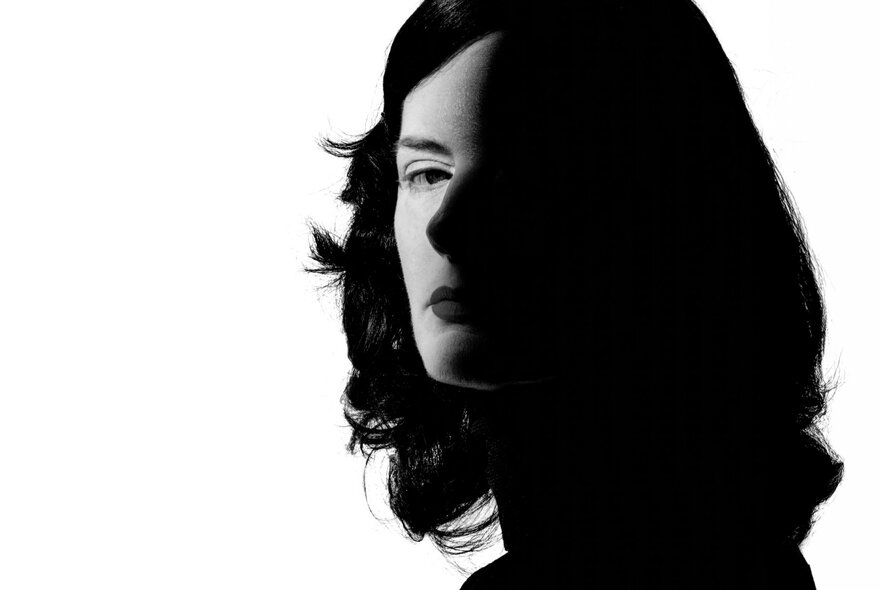 Woman's face, silhouetted in shadow.
