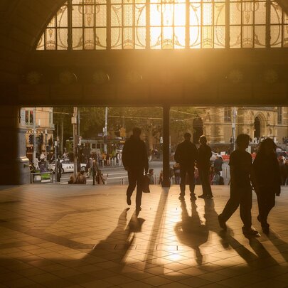 The sun setting through the main entrance of Flinders Street Station.