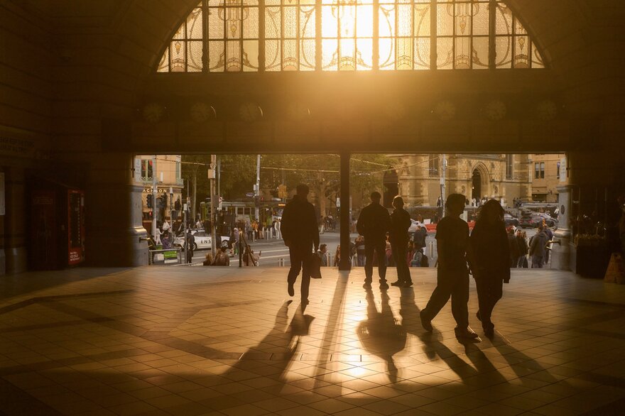 The sun setting through the main entrance of Flinders Street Station.