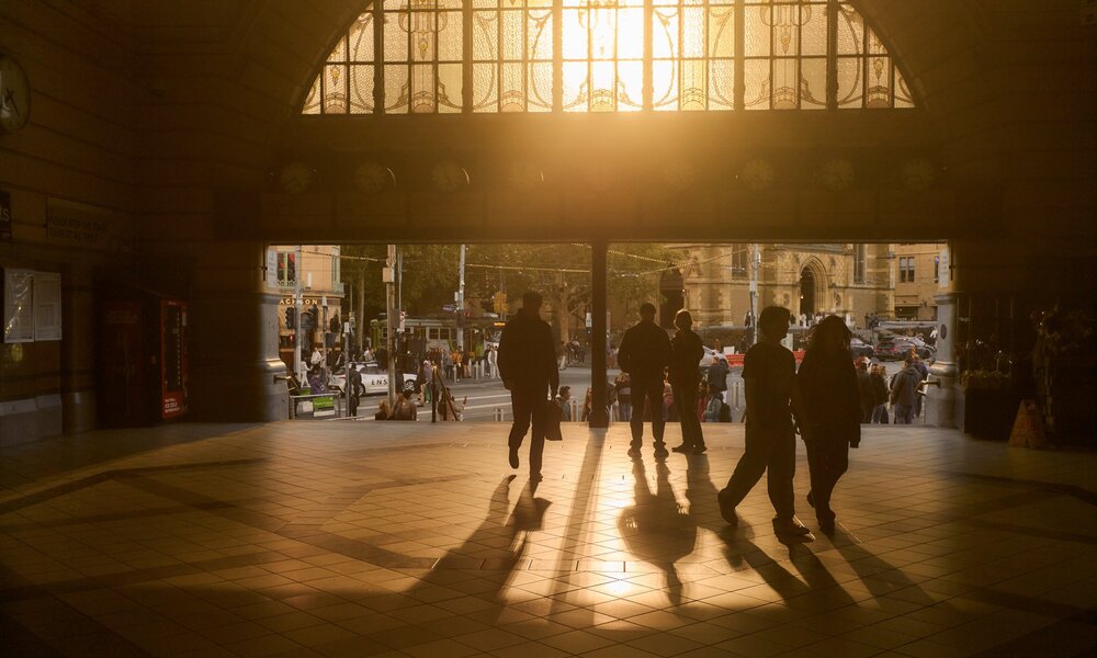The sun setting through the main entrance of Flinders Street Station.